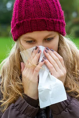 woman blowing her nose