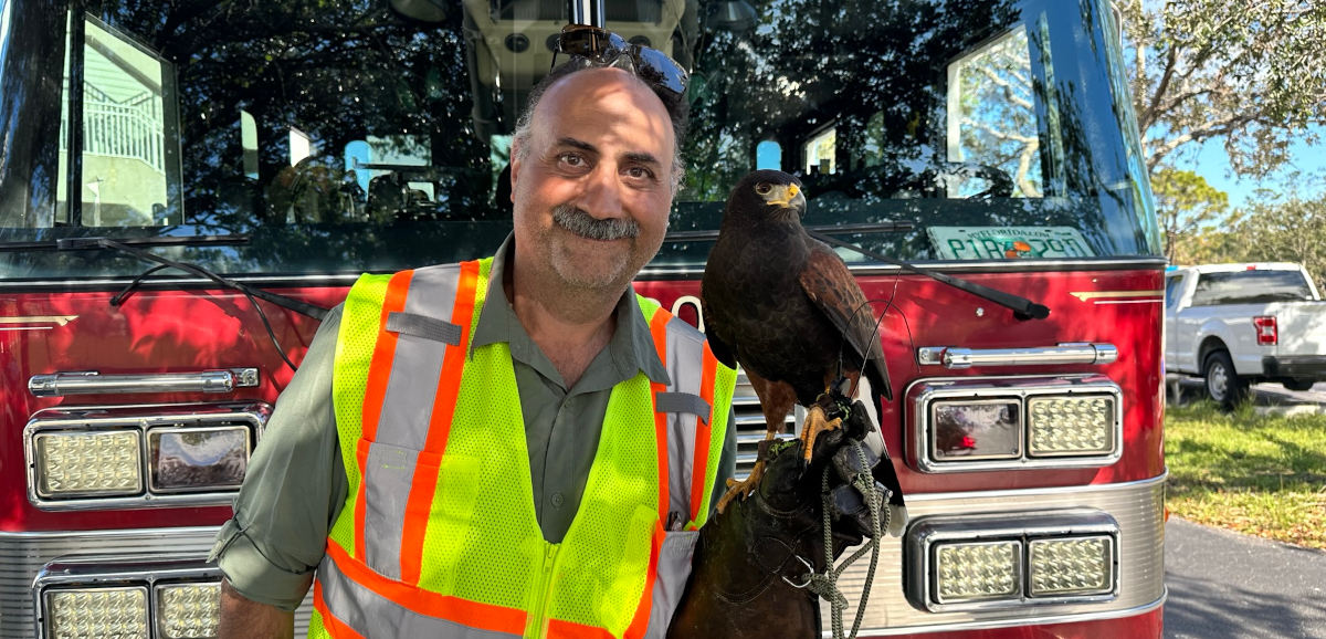Dan Frankian with hawk in front of fire truck